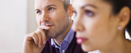 Close up on woman in the foreground and man in the background