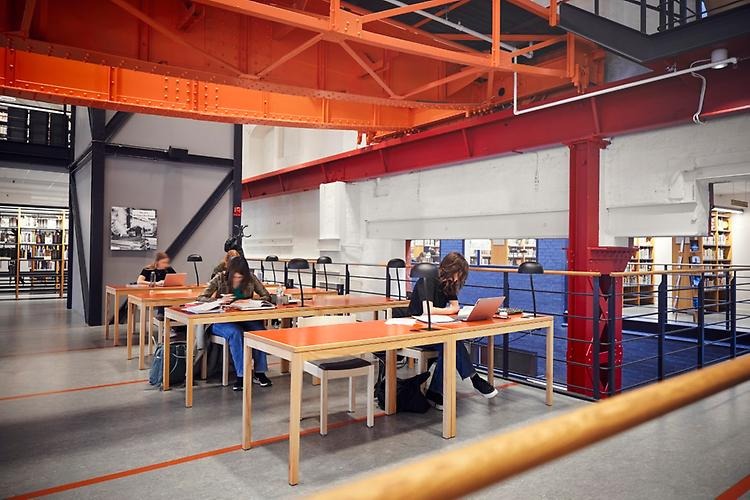 Rows of study seats. A couple of students are studying.
