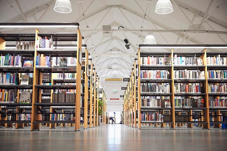 Long rows of bookshelves full of books.