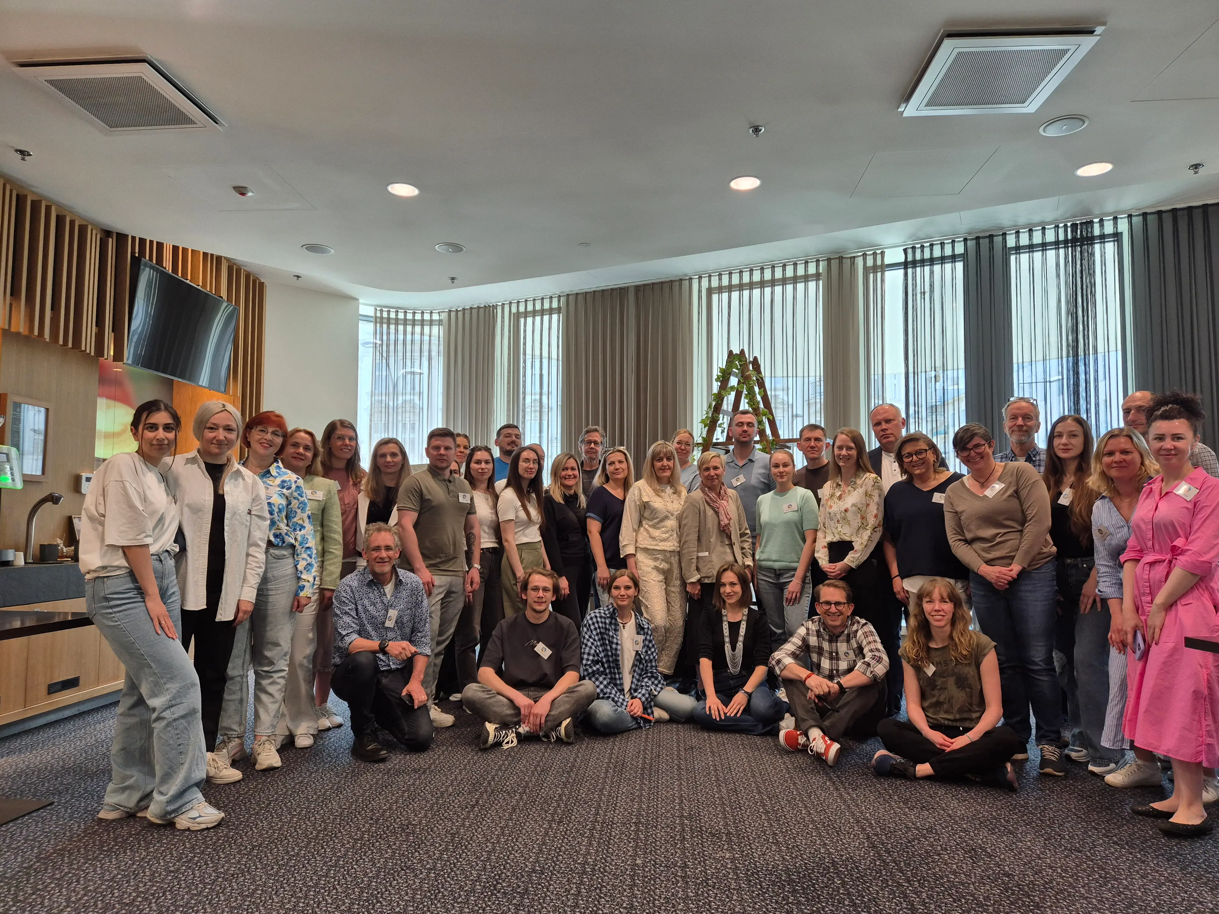 A large group of people smile and look at the camera