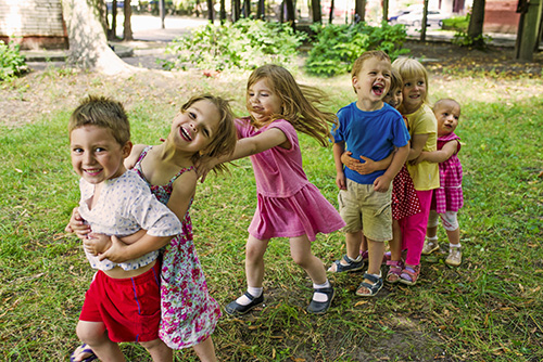 happy children outside in a row