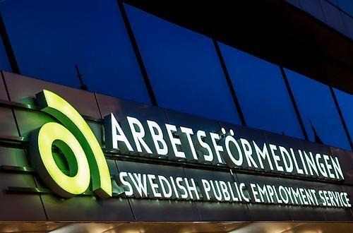 Neon sign over job employement agency building. 