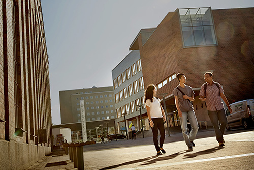 Three students walking from HLK