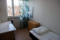 Student dorm room with bed and desk