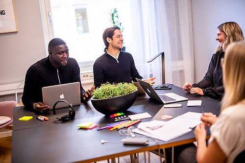 Four people sitting around a table